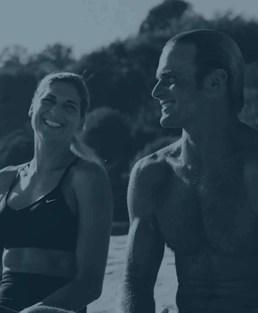 Laird Hamilton surfing a large wave, symbolizing the brand's high-performance wellness ethos